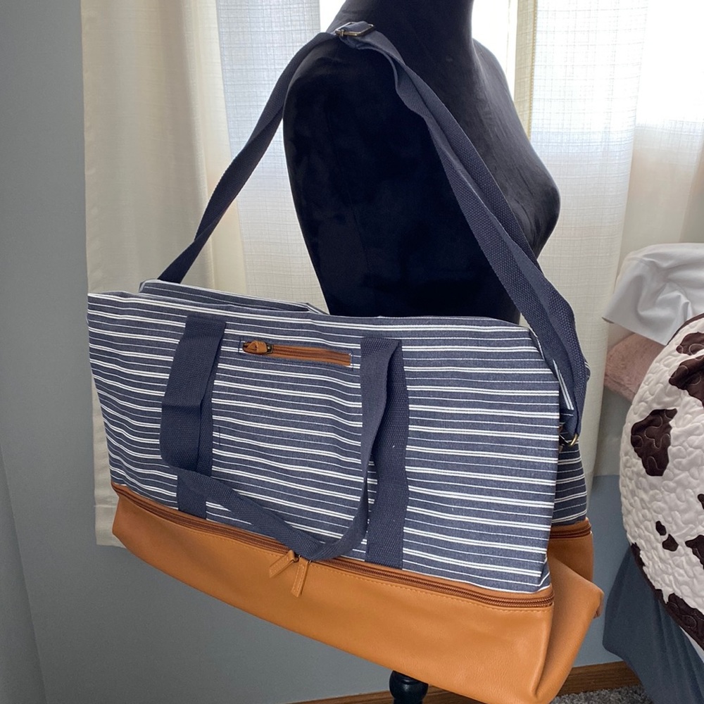 NIP weekender bag with adjustable and removable strap.